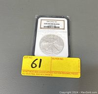 Top view of the coin encased in a protective holder with NGC certification label showing "2006 EAGLE $1 GEM UNCIRCULATED" and barcode.