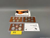 Full view of the 2014 US Mint Proof Set including three acrylic holders with coins, original box, and certificate of authenticity.