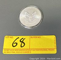 Top view of the reverse side of the 2015 US Silver Eagle showing eagle with shield and text.