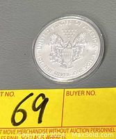 Reverse side of the 2015 Silver Eagle coin showing the heraldic eagle design with inscriptions.