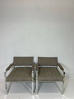 Front view of both lounge chairs showing chrome frames and tweed upholstery