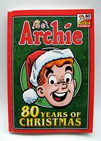 Front cover of the softcover Archie Comics 80 Years of Christmas book showing the character Archie in a Santa hat and the title prominently displayed.