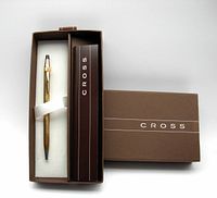 Gold-filled ball-point pen in original brown Cross branded box with white fabric lining.
