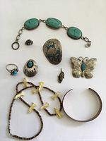 Full lot of American Indian sterling silver and turquoise jewelry pieces including bracelet, ring, brooch, earrings, pendant, fetish necklace and cuff bracelet.