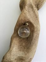 Front view of the locket pendant displayed on a textured wooden surface.