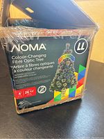Box of NOMA Colour-Changing Fibre Optic Tree showing brand, series, size, and color-changing feature