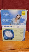 Front view of the Litebook Elite box showing branding, product image, and slogan 'The light you need... every day'.