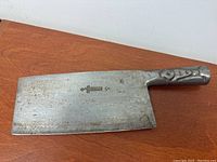 Full view of the metal handled meat cleaver showing overall size and condition