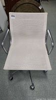 Front view of chair showing white mesh seat, backrest, and aluminum armrests