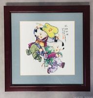 Front view of framed porcelain artwork depicting two children in traditional clothing with a blue mat and wooden frame.