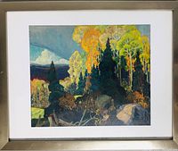 Photo of framed Group of Seven print featuring a vibrant autumn forest scene with varied tree colors and rocky foreground