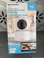 Front view of the Merkury Smart Wi-Fi Auto-Follow Camera box showing the product image and HD 1080p label.