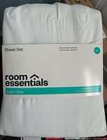 Front packaging label showing Room Essentials brand, Easy-Care series, white sheet set for full/double bed, brushed for softness and wrinkle resistant.