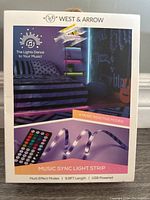 Front of sealed product box showing branding, product image, and features such as music reactive modes, length, USB powered.