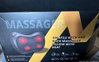Box of the shiatsu neck and back massager showing massager image and features including shiatsu massage and heat