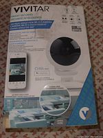 Front of the Vivitar Smart Security Wifi Camera box showing product image, 360° wide angle view, digital pan-tilt-zoom, full HD 1080p, and phone app display.
