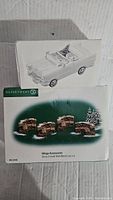 Boxed Dept 56 Village Accessories Stone Curved Wall/Bench set with an image of a Cadillac convertible model car on top of the box, showing packaging and product visuals.