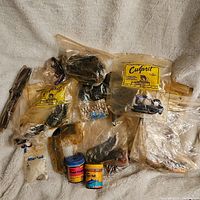 Lot of assorted vintage fishing lures mostly in plastic packaging including original Culprit bags and two bait attractant containers.