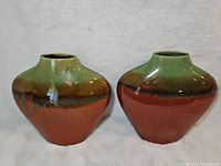Front view of both pottery vases showing gradient glaze and shape