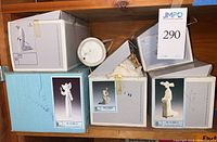 Boxes containing Lladro figurine lot from top view, including original packaging
