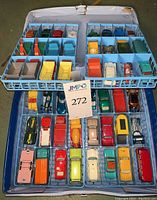 Overall view of two-piece light blue plastic carrying case filled with 48 die-cast vehicles