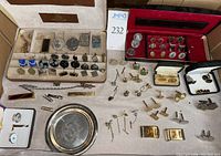 Overview of entire lot spread on cloth, showing cases, trays, cufflinks, clips and bars