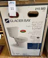 Photo of Glacier Bay box showing product model number, front view of the toilet, and key product features.
