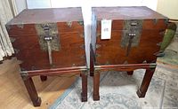 Two identical tansu chest-and-plinth assemblies side by side
