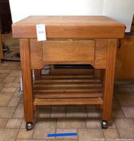Front view of full cart showing drawer, lower shelf and casters