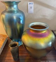 Overview of all three vases on wooden surface