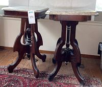Two wooden vintage end tables with marble tops, shown side by side, highlighting different sizes and bases.