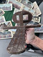 Top view of antique oak stereo scope viewer held in hand showing wood grain and lenses.