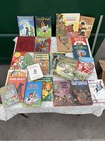 Full overview of all 22 children's books displayed on a table with colorful covers and titles visible.