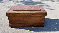 Front view of large pine blanket box trunk showing warm honey finish and recessed lid.