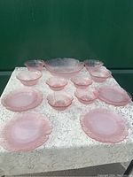 Full display of the set on a lace tablecloth showing all 13 pieces including plates and bowls