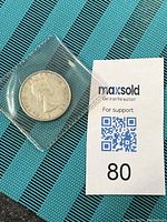 1962 Canadian 50 cent coin inside a protective plastic sleeve, showing the obverse side with Queen Elizabeth II.