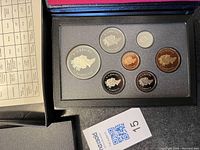 Photo showing the full set of six Canadian coins from 1990 inside the black foam holder within a presentation case.