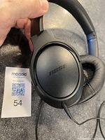 Close-up of the Bose logo on the ear cup showing headphone design and brand.