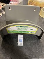 Front view of grey plastic garden hose hanger with label indicating Home Gardener brand and product details.