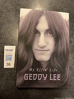 Front cover close-up portrait photo of Geddy Lee on the book titled 'My Effin' Life'.