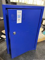 Blue metal key box closed showing front door with lock