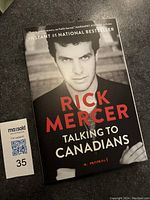 Front cover of 'Talking to Canadians' memoir by Rick Mercer showing portrait and title.