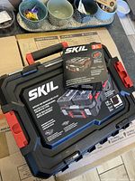 Photo showing all three Skil hardware cases stacked with product label and tags