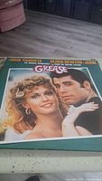 Vinyl record cover featuring John Travolta and Olivia Newton-John from the movie Grease, showing the front cover art.