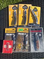 All 7 cutting tools laid out on a black surface outdoors, still in original packaging