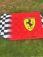 Ferrari flag with checkered pattern fading to red and Ferrari emblem