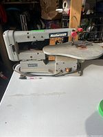 Front angled view of the Mastercraft scroll saw showing the entire base, table surface, and arm with the Mastercraft branding.