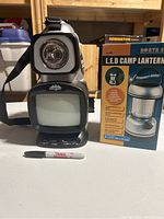 Tera Gear North 49 LED camp lantern with lantern box and Sharpie for scale.