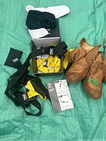 TRX suspension training system parts and vintage boxing gloves on green background