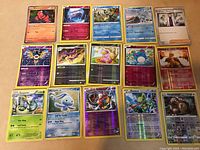Full lot of 15 holographic Pokémon cards arranged clearly showing card details and layout.